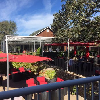 Mumm Napa - Red umbrella tables = reserved seating for Oak Terrace tasting - Wine Tasting Room Near Me - Rutherford, California