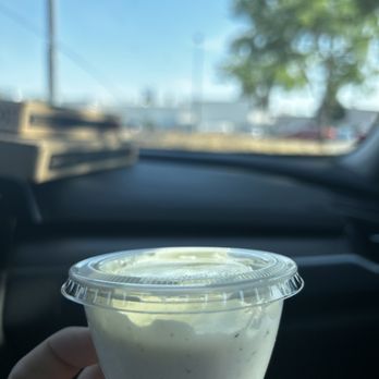 Me-n-Ed's Pizzeria - ows a hand holding a cup of yogurt - Pizza Near Me - Selma, California Me-n-Ed's Pizzeria - ows a hand holding a cup of yogurt - Pizza Near Me - Selma, California
