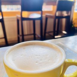 a cup of coffee on a table a cup of coffee on a table