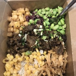 Beef Bulgogi bowl (build your own). With pineapple salsa, edamame, fried onions, & corn. Topped with Miso Sesame & green onions