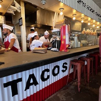 The Taco Stand - Standing in a second line for salsa and looking left you can see the workers cook and assemble the orders. - Food Stands Near Me - La Jolla, California The Taco Stand - Standing in a second line for salsa and looking left you can see the workers cook and assemble the orders. - Food Stands Near Me - La Jolla, California