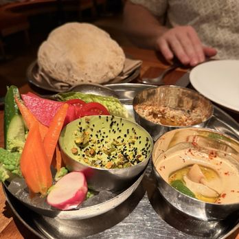 Callie - Assorted spreads and breads: roasted garlic hummus, smokey babaghanoush, and avocado labneh, served with crudité and hot pita - Mediterranean Near Me - San Diego, California