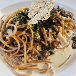 a plate of spaghetti with mushrooms and parmesan cheese a plate of spaghetti with mushrooms and parmesan cheese