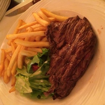 Café de Paris - Steak frites. I think the cut was a beef hangar steak. Maybe skirt steak. Deliciously rare; they don't kill the cow twice here. - Cafes Near Me - Paris, 75 Café de Paris - Steak frites. I think the cut was a beef hangar steak. Maybe skirt steak. Deliciously rare; they don't kill the cow twice here. - Cafes Near Me - Paris, 75