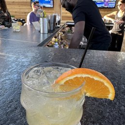 a glass of lemonade with a slice of orange