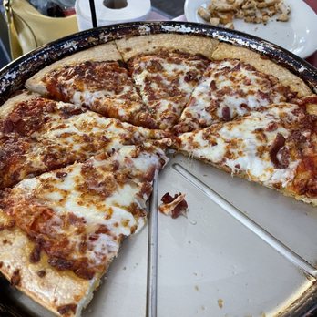 Pizza Hut - a half eaten pizza on a pan - Pizza Near Me - Gladwin, Michigan