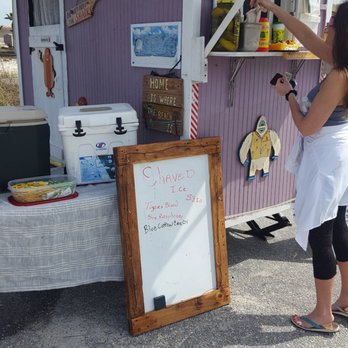 Paradise Snow - a woman taking a picture of a food stand - Shaved Ice Near Me - Orange Beach, Alabama