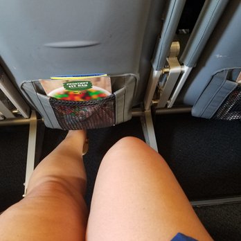 Frontier Airlines - Row 12 legroom. The bended knee is sitting normal. The other leg is fully stretched out. Tons on room - Airlines Near Me - Miami, Florida Frontier Airlines - Row 12 legroom. The bended knee is sitting normal. The other leg is fully stretched out. Tons on room - Airlines Near Me - Miami, Florida