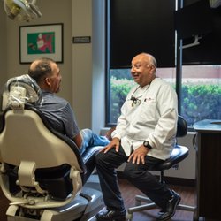 Legacy Dental - Meet Dr. John Borroso discussing a treatment plan with his patient