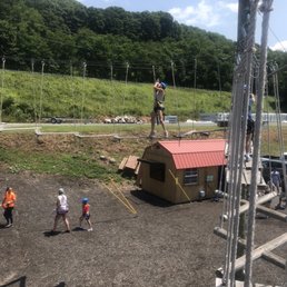 Kid going across one of the obstacles with boards that shifted as you walk Kid going across one of the obstacles with boards that shifted as you walk