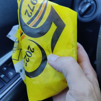 Taco Casa - a hand holding a taco bag - Mexican Near Me - Keller, Texas
