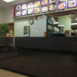 a restaurant counter with a menu in the background a restaurant counter with a menu in the background