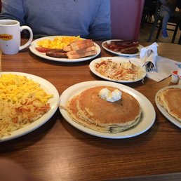 a breakfast of pancakes, eggs, hash browns and bacon a breakfast of pancakes, eggs, hash browns and bacon