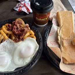 The full breakfast eggs, bacon, fries, Cuban toast and cafe con leche. Delicious The full breakfast eggs, bacon, fries, Cuban toast and cafe con leche. Delicious