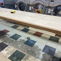 Ton-O-Suds Laundromat - Disgusting floors.  3 out of 4 of these big load washers out of order and both of the only larger load front loaders were also out of order.