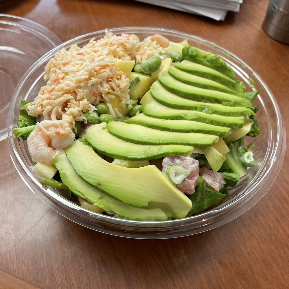 Poke bowl with tuna, shrimp, avocado, Kani salad with other goodies over a bed of greens with wasabi aioli Poke bowl with tuna, shrimp, avocado, Kani salad with other goodies over a bed of greens with wasabi aioli