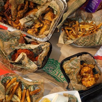Wingstop - a variety of food items on a table - Chicken Wings Near Me - San Diego, California Wingstop - a variety of food items on a table - Chicken Wings Near Me - San Diego, California