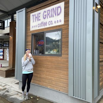 The Grind Coffee Company - a woman standing in front of a coffee shop - Coffee & Tea Near Me - Juneau, Alaska The Grind Coffee Company - a woman standing in front of a coffee shop - Coffee & Tea Near Me - Juneau, Alaska