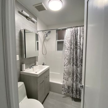 Covenant Contracting Group - a bathroom with a toilet, sink, and shower - General Contractors Near Me - Long Island City, New York Covenant Contracting Group - a bathroom with a toilet, sink, and shower - General Contractors Near Me - Long Island City, New York