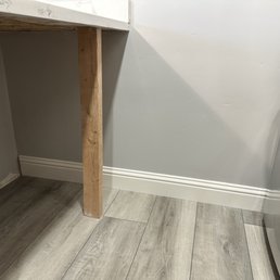 Kitchen wall repaired and painted, ready for the cabinets to be installed.