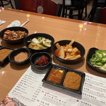 Jang Choong Dong - Spread of banchan (side dishes:  kimchi, pickled onions, pickled radish) + sauces - Korean Near Me - Houston, Texas