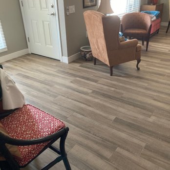 Bare Floors - a living room with a chair and a couch - Carpet Installation Near Me - Phoenix, Arizona Bare Floors - a living room with a chair and a couch - Carpet Installation Near Me - Phoenix, Arizona