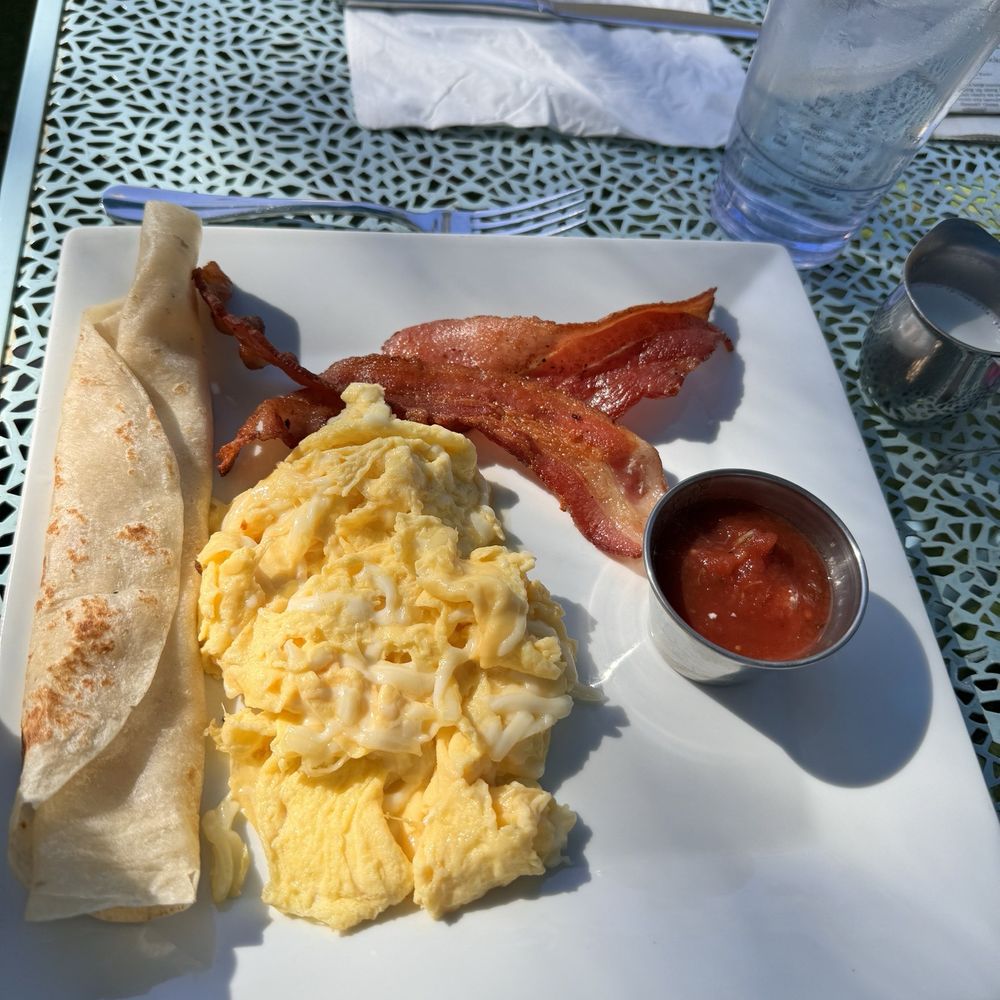Naked Cafe - Cheesy scrambled eggs, flour tortilla and crispy bacon. - Breakfast & Brunch Near Me - Encinitas, California Naked Cafe - Cheesy scrambled eggs, flour tortilla and crispy bacon. - Breakfast & Brunch Near Me - Encinitas, California