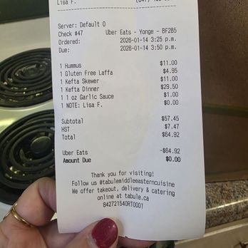 Tabule Restaurant - Price point was great - A printed receipt from Tabule Restaurant in Toronto shows an Uber Eats order with items like hummus, gluten-free laffa, and kefta skewers, dated January 14, 2026. - Middle Eastern Near Me - Toronto, Ontario