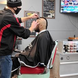 Uppercuts Barbershop - Mohawk, & razor tight on the sides, by barber Justin Moon.
