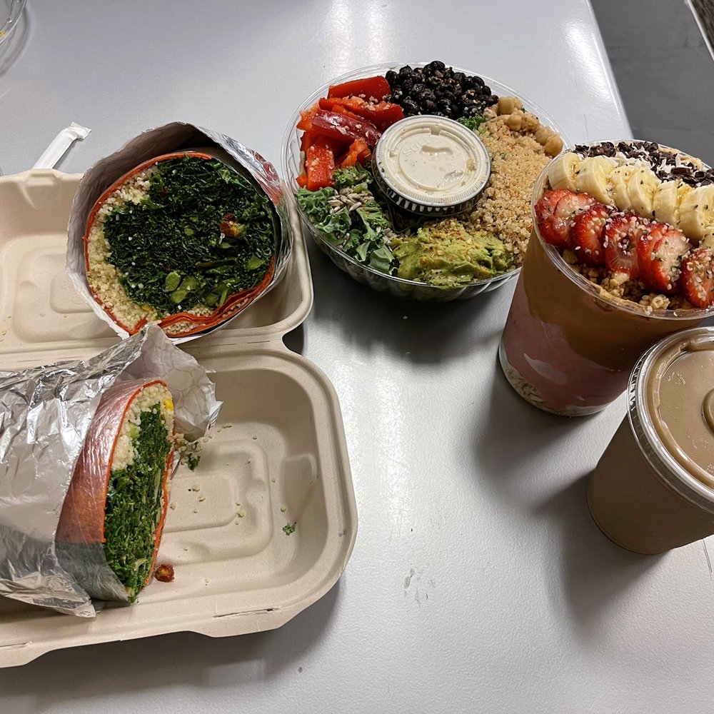 a sandwich, salad, and drink on a table