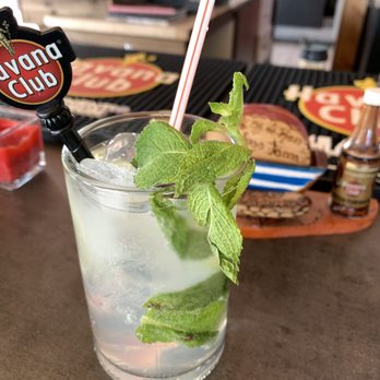 Somos Cuba - a mojit with mint leaves and a straw - Cuban Near Me - Quebec City, Quebec Somos Cuba - a mojit with mint leaves and a straw - Cuban Near Me - Quebec City, Quebec
