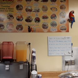 La Placita - Affordable Menu on the wall and important Message. FRuity sweet Mexican non alcoholic beverages including 'Tamarind' on the left