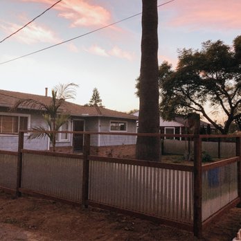 Coastal Construction & Property Maintenance - a fenced in yard with a tree - Handyman Near Me