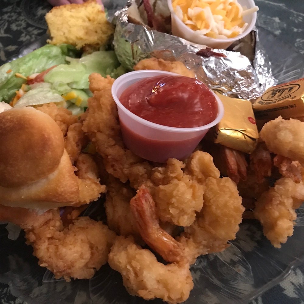 Fried shrimps with salad and loaded baked potato Fried shrimps with salad and loaded baked potato