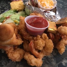 Fried shrimps with salad and loaded baked potato Fried shrimps with salad and loaded baked potato