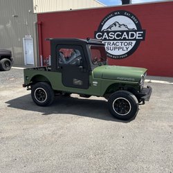 Cascade Tractor Supply - 2026 Mahindra ROXOR All Weather Edition in Mahindra Green with a fully enclosed cab, hard doors, heater, and rugged steel construction.