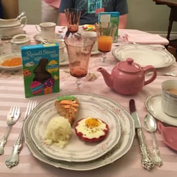 Beautiful Easter breakfast of eggs in a ham cup, southern grits and a carrot cake scone.
