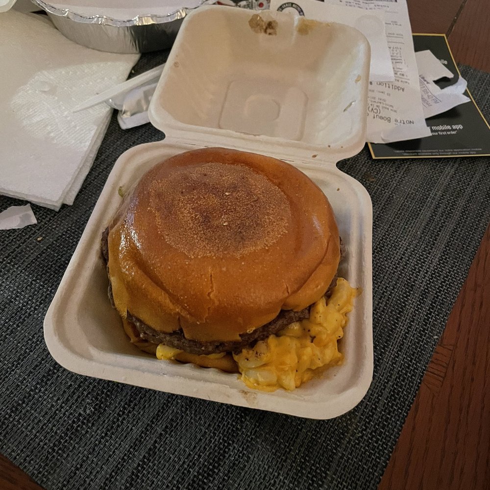 Notre-Boeuf-de-Grâce - shows a hamburger and eggs in a styrofoam container - Burgers Near Me - Montreal, Quebec Notre-Boeuf-de-Grâce - shows a hamburger and eggs in a styrofoam container - Burgers Near Me - Montreal, Quebec