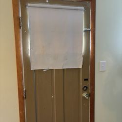 Red Ranch Motel - Door with paper taped over it instead of a shade.