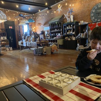 Five North Coffee + Gifts - a boy eating a donut - Coffee & Tea Near Me - Deer Park, Washington Five North Coffee + Gifts - a boy eating a donut - Coffee & Tea Near Me - Deer Park, Washington