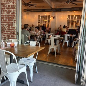 Oakhart Social Restaurant - Wooden tables with metal chairs inside and out. - New American Near Me - Charlottesville, Virginia Oakhart Social Restaurant - Wooden tables with metal chairs inside and out. - New American Near Me - Charlottesville, Virginia