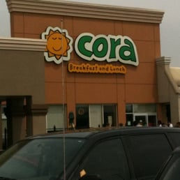 cars parked in front of a restaurant