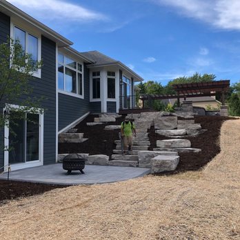 Extreme Exteriors - lower paver patio with stone seating and steps to upper area - General Contractors Near Me - Big Bend, Wisconsin
