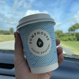 a hand holding a cup of coffee