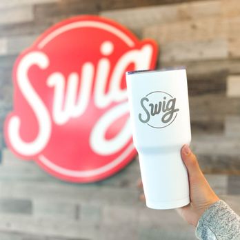 Swig - a person holding a cup in front of a swig logo - Desserts Near Me - McKinney, Texas