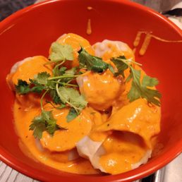 Butter chicken, with steamed chicken Momos . Butter chicken, with steamed chicken Momos .