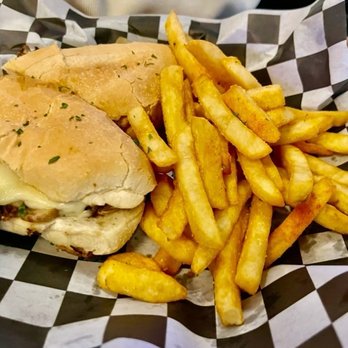 Ashburn Pub - The Philly cheesesteak with a side of seasoned french fries - American Near Me - Ashburn, Virginia