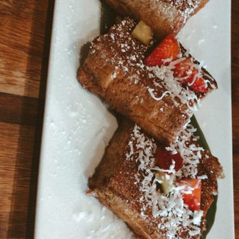 Scratch Kitchen - Brulee'd French Toast! Deliciousness topped with shredded coconut, strawberries, bananas, and powdered sugar. - Breakfast & Brunch Near Me - Honolulu, Hawaii