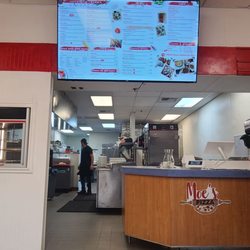 Moe's Pizza - Menu and kitchen area.