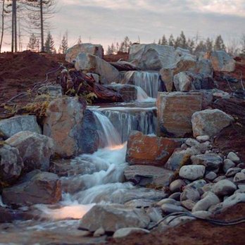 Pride Hardscape Construction - a waterfall in a rocky area - Landscaping Near Me Pride Hardscape Construction - a waterfall in a rocky area - Landscaping Near Me